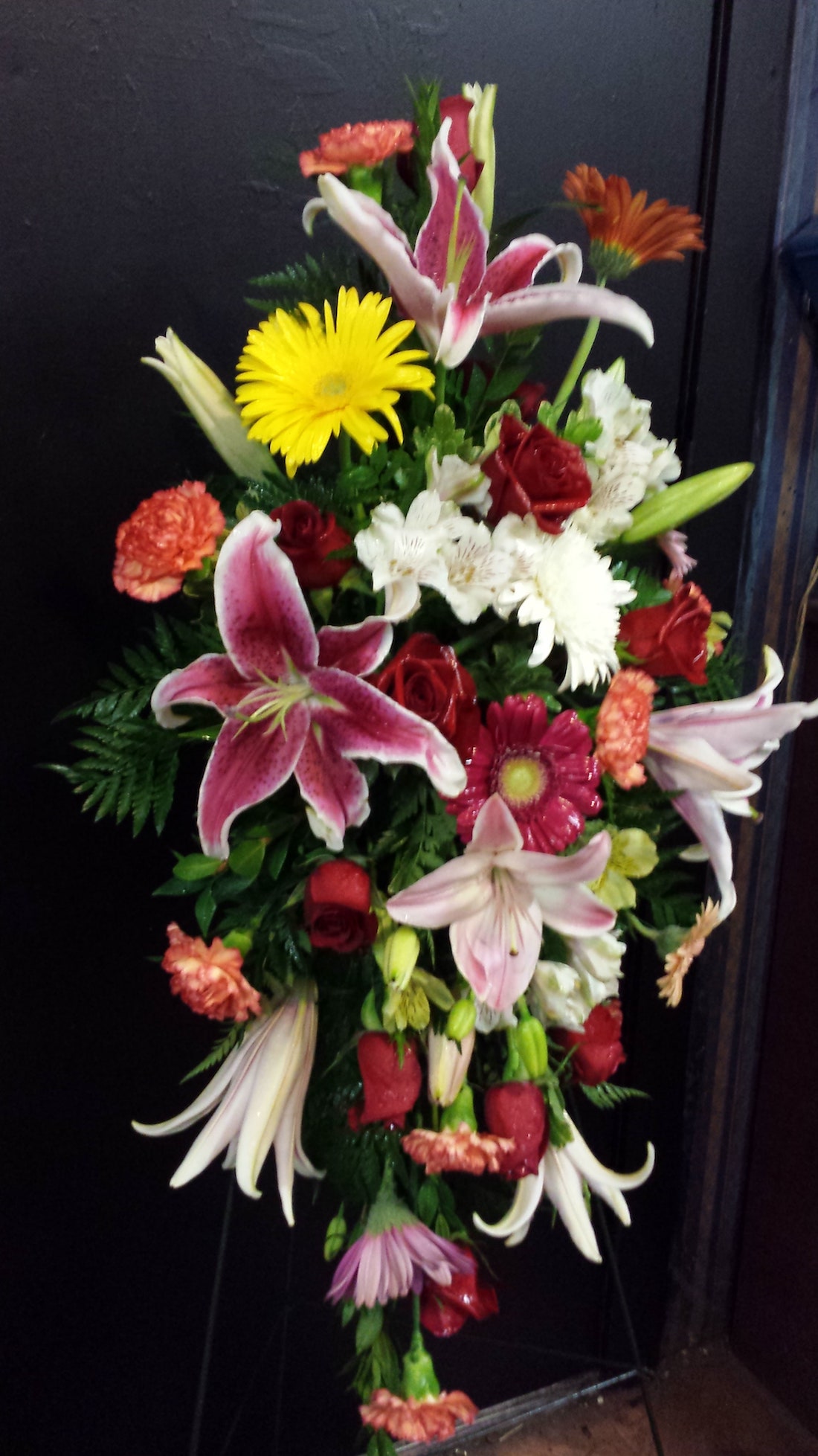 A Standing Spray Easel With Stargazers Carnations Gerbera Poms Roses Stock