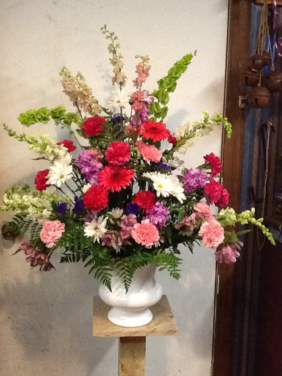 Carnations Alstroemeria Gerbera Daisy Snap Dragons Poms and Larkspur in an Urn