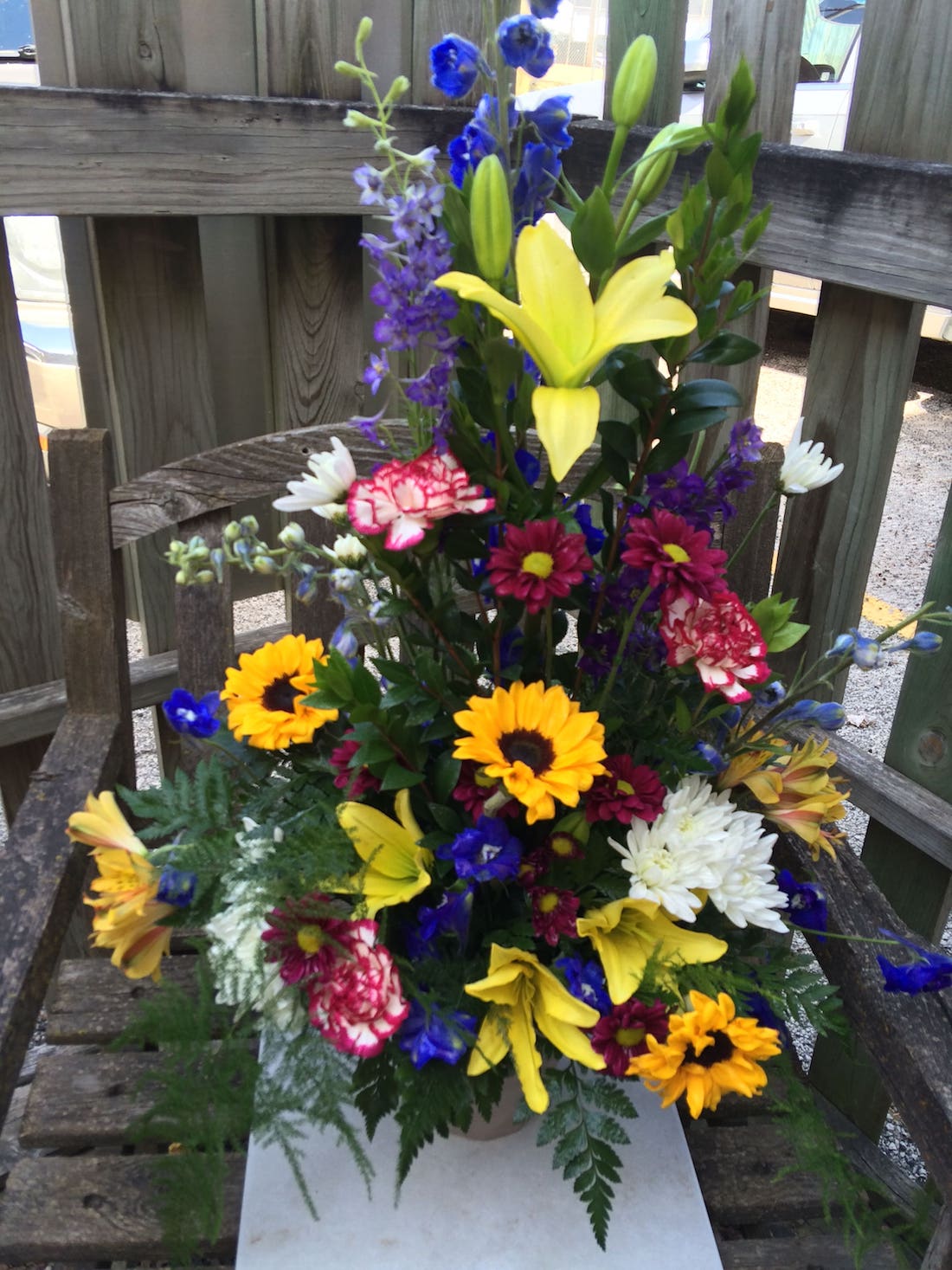 Sunflowers Lilies Carnations Poms Delphinium In an Urn